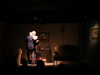 (Image: Man and a Woman Dance in a Dimly Lit Reception Room)