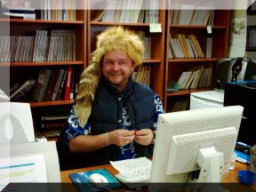 Ingo at the front desk wearing The Hat