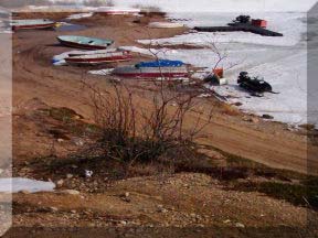 The boats and snowmobiles on the beach along the way to work